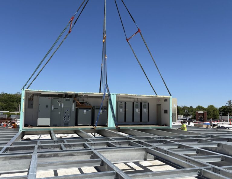 Prefabricated electrical penthouse being craned onto the roof at Uncle Giuseppe's Marketplace, Greenvale NY